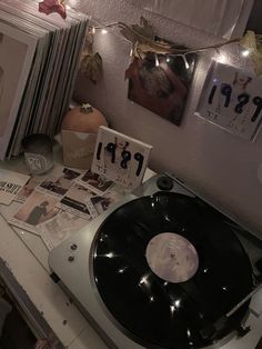 an old record player sitting on top of a table next to pictures and other items