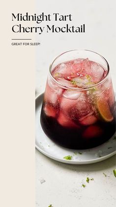 a drink in a glass sitting on top of a white plate