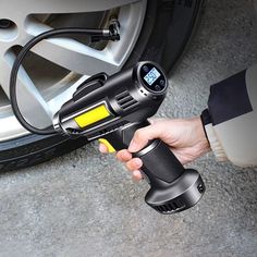 an image of a person using a car tire pressure gauge to test the air temperature