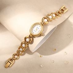 Are you ready to attract everyone's envious gaze? This vintage gold pearl women's watch is like a piece of jewelry in a classic movie, instantly making you the focus of the audience. The golden dial is like the autumn sun, and the pearl-like decoration shines with charming light. Every gaze is like a dialogue with time. The most special thing is that this watch is customized with a name and is purely handmade! 👀 Warm Tips: The watch can be resized by linking the disassembly tool (the disassembl Metal Watches With Round Dial For Anniversary, Metal Watch Accessories With Round Dial For Gift, Elegant Metal Watch With Round Dial, Metal Analog Watch Accessories As Gifts, Metal Watches Suitable For Gifts, Metal Watches With Round Dial For Gift, Metal Watch With Round Dial For Gift, Metal Watches Gift, Metal Analog Watches With Adjustable Fit