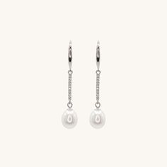 Elevate your style with these stunning sterling silver dangling pearl earrings. These versatile earrings are suitable for any occasion, making them an essential addition to your jewelry collection. For a complete look, pair them with our classic pearl bracelet or necklace collection.