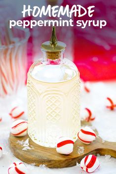 homemade peppermint syrup in a glass bottle with candy canes around it