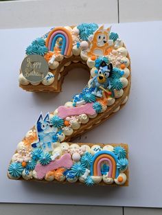 the number two is made out of cookies with frosting and decorations on it's sides