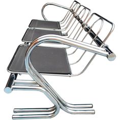 a metal chair with four chairs attached to it's back legs and one on top of the other