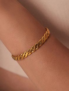 This Braided Cuff Bracelet features a meticulously braided cuff design, exuding elegance and sophistication. The slightly adjustable design ensures a perfect fit, catering to individual preferences with ease. Crafted from 18k gold-plated stainless steel, it combines timeless beauty with enduring quality. The lustrous gold finish not only catches the eye but also radiates an undeniable sophistication that seamlessly transitions from casual chic to upscale glamour. Specifications: Materials: 18k G Adjustable Gold Cuff Bracelet For Formal Occasions, Trendy Braided Jewelry, Adjustable Gold Bangle With A Modern Twist, Classic Gold Adjustable Braided Bracelets, Classic Gold Braided Adjustable Bracelet, Classic Adjustable Gold Braided Bracelets, Classic Adjustable Braided Bangle Bracelet, Adjustable Yellow Gold Bracelets With A Modern Twist, Elegant Adjustable Cuff Bracelet With Jubilee Design