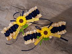 two sunflower garters with name tags on them sitting on a wooden floor