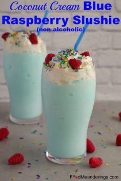 two glasses filled with ice cream and raspberry slushie on top of a table