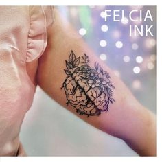 a woman's arm with a flower tattoo on it