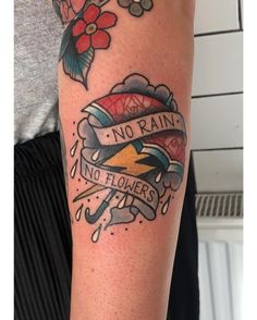 a man with a tattoo on his arm and no rain, no flowers written in it