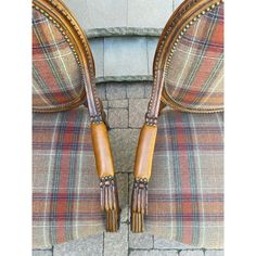 two brown leather chairs with wooden handles