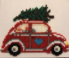 a red car with a christmas tree on the roof is made out of legos