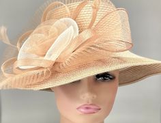 "The featured hat is a strikingly gorgeous amber and ivory hat. A beautiful crinoline design with swirls of amber and ivory. A fanned out amber crinoline disc forms the backdrop of the design. Several loops of tan in sinamay adorn the edges of the design. This classic hat is a beautiful Kentucky Derby hat, Easter Hat, Tea Party hat, Wedding Party Hat, Downton Abby Hat,Auntie Hat , Fancy Dress Hat and for all formal events and other special occasions. Brim:   6\" Rise:   4\" Size:   22\"" Cream Fedora Sun Hat For Kentucky Derby, Kentucky Derby Cream Fedora Sun Hat, Beige Boater Hat For Formal Spring Occasions, Beige Church Hat For Spring, Spring Beige Hat For Church, Beige Sun Hat For Church In Spring, Beige Spring Church Hat, Cream Fedora Hat For Garden Party, Beige Short Brim Fascinator For Garden Party