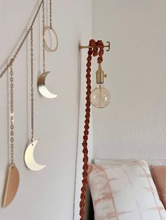 the moon and crescent lights are hanging on the wall above the bed, along with other decorative items