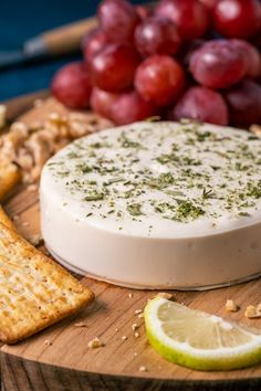 vegan goat cheese with crackers and grapes in the background