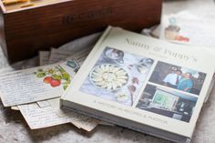 many photographs are stacked on top of each other next to a wooden box with writing