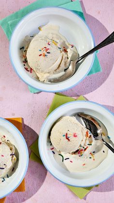 two bowls filled with ice cream and sprinkles on top of a table