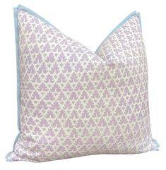 a purple and white pillow with blue piping on the front, sitting against a white background