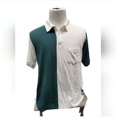 This vintage Windridge polo shirt is a must-have for any fashion-savvy man. The colorblock pattern in green and white adds a touch of 90s style to your wardrobe. The short sleeves and collared neckline make it perfect for a day on the golf course or a casual outing.  Made from a comfortable polyester blend knit fabric, this polo shirt is both stylish and functional. The XL size and regular fit ensure a comfortable and flattering fit for any body type. Don't miss out on the opportunity to add this unique piece to your collection. 90s Style, Fashion History, Golf Course, Green And White, 90s Fashion, Unique Pieces, Color Blocking, Color Block, Knit Fabric