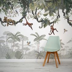 a wall mural with monkeys and other animals on it's side, in front of a chair