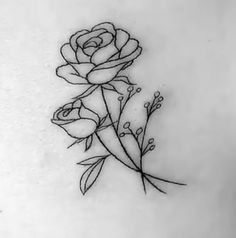 a black and white photo of a rose tattoo