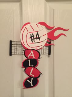 a volleyball themed door hanger with the number 4 on it