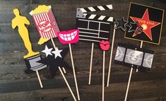 some cupcake toppers that are sitting on a table with film claps and stars