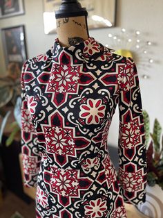 "Adorable vintage 1960s mod mini dress. Long sleeve and turtleneck. Dress has a geometric floral print in white, red, and black. In excellent vintage condition! Measurements  Chest 16\" Waist 13\" Length 36\" Follow our Instagram for reduced pricing on this dress and all of our other items listed! @vintage_envy_and_exotics FREE delivery or pick up in Bay Area (Oakland & SF)" Fitted Floral Print Dress With High Neck, Fitted High Neck Dress With Floral Print, Vintage Red Mini Dress For Fall, Vintage Long Sleeve Printed Dress, Fitted Long Sleeve Tops With Vintage Pattern, Retro Stretch Dresses For Fall, Retro Red Long Sleeve Mini Dress, Chic Fitted Dress With Bold Print, Retro Fitted Mini Dress For Fall