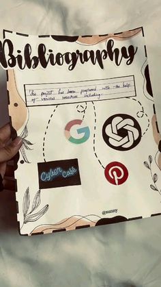 a person holding up a paper with some type of logo on it that says bibliogrammy