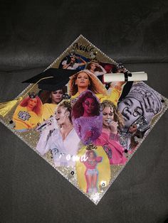 a graduation cap with pictures of women on it and a pen laying next to it