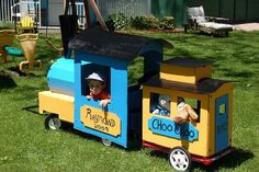 a small child's toy train sitting in the grass