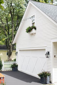 a white house with flower boxes on the roof