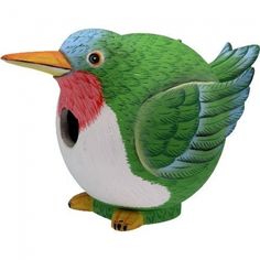 a green and white bird sitting on top of a table