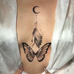 a woman with a butterfly tattoo on her stomach and the moon behind her back shoulder