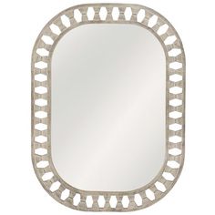 a white mirror with an intricate design on the bottom and sides, against a white background