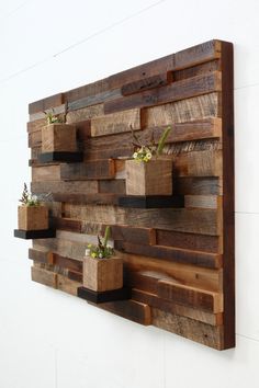 a wooden wall hanging with planters on it