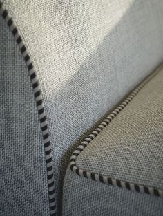 a close up view of the back of a couch with black and white lines on it