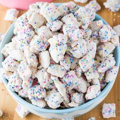 a blue bowl filled with sprinkles and white dog treats