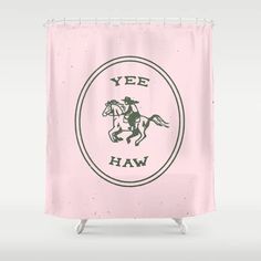 a pink shower curtain with the words yee haw on it