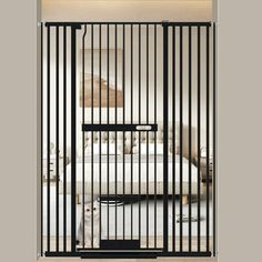 a black gate is open to reveal a bed