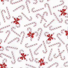 candy canes and bows on white paper with red thready ribboned bowes