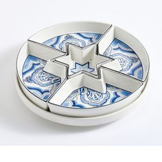 a blue and white plate with four stars on it