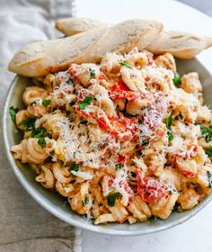 a bowl filled with pasta and bread on top of a table