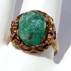 "Vintage Chinese Export ring, made of approx. 20 K (.833) yellow gold. It features dragon figure around the rough Emerald crystal. Band is textured. It is marked \"BO\" and \"JS\" on the inside. This stunning ring is a size 8, 3/4\" at the widest and weighs 5.9 grams. The stone is a little loose, needs to see a jeweler. EA72" Antique Gold Rings With Emerald, Unique Gold Emerald Ring Birthstone, Collectible Gold Emerald Gemstone Ring, Collectible Gold Emerald Ring With Gemstone, Gold Emerald Ring Collectible, Emerald Crystal, Dragon Ring, Chinese Export, Ring Emerald