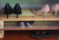 three pairs of shoes are lined up on a shelf