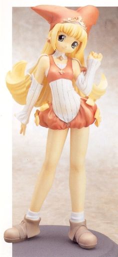 a figurine is posed on top of a stand with her hands in the air