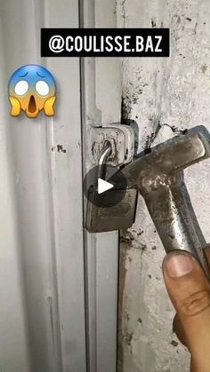 a person holding a wrench in front of a door