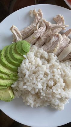 rice, avocado and chicken on a white plate