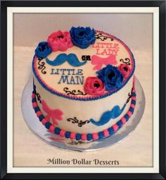 a birthday cake decorated with pink, blue and white frosting for a little man