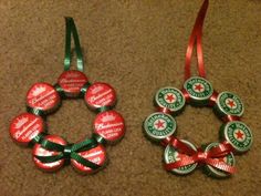 two christmas ornaments made out of beer caps and ribbons on the floor next to each other