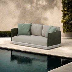 a couch sitting next to a swimming pool